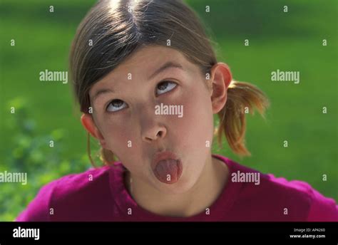 Girl Sticking Tongue Out Stock Photo Alamy