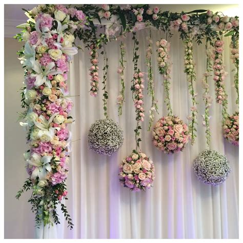 Hanging Flower Balls With A Solid Flower Edging Stage Backdrop