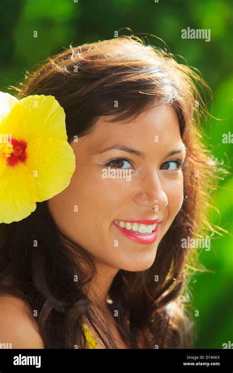 Hawaii Oahu Beautiful Headshot Of A Young Girl With A Hibiscus In Her