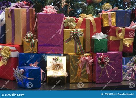 Brightly Wrapped Presents Stacked Under The Christmas Tree Stock Image
