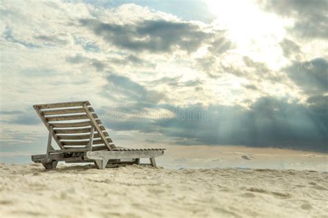 Wooden Beach Chair On White Sand Beach With Beautiful Sky Stock Photo