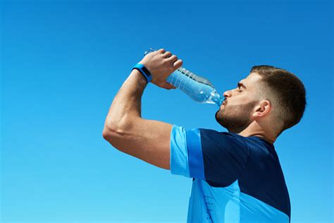 Man Drinking Water After Running Portrait Stock Photo Download Image