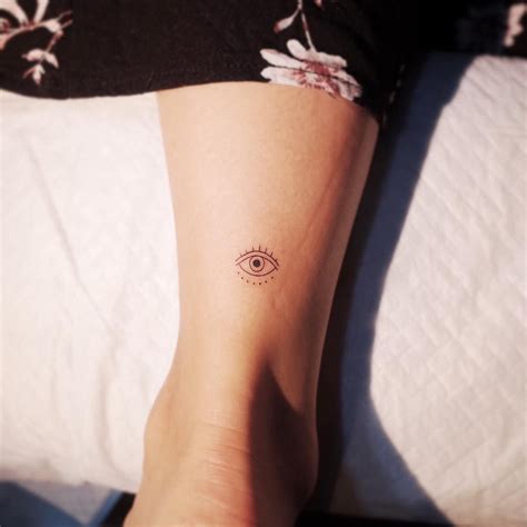19 Tiny Tattoos To Get In An Unexpected Place Protection Tattoo Evil
