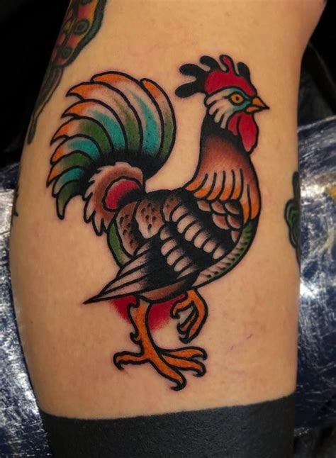 A Colorful Rooster Tattoo On The Leg