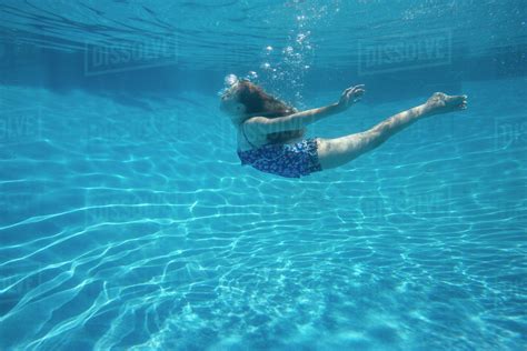 A Child Swimming Under Water In A Swimming Pool Stock Photo Dissolve