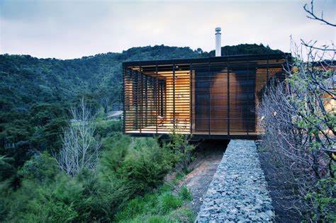 Stone And Timber Clad Hilltop Residence Integrates With The Environment