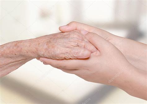 Woman Holding Her Grandma Hand In Bedroom Stock Photo By ©parinyabinsuk