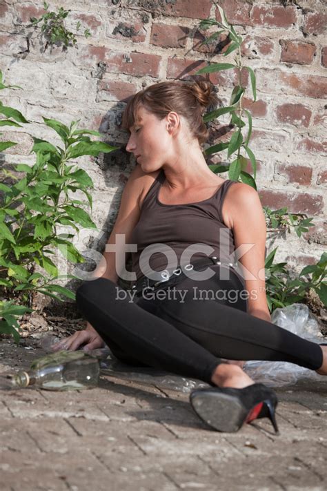 Drunk Woman At The Brick Wall Stock Photos