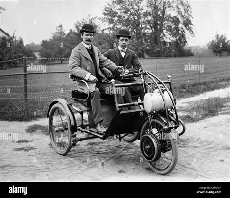 1900s Two Men In Bowler Hats Sitting In Three Wheel Motorized Horseless