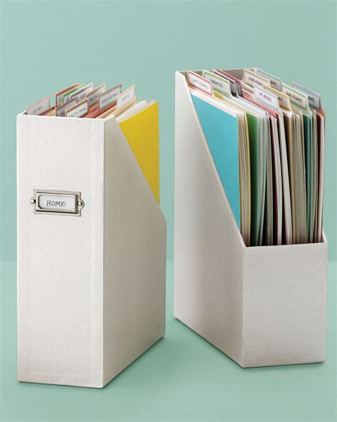 Two White File Cabinets Filled With Files And Folders Next To Each