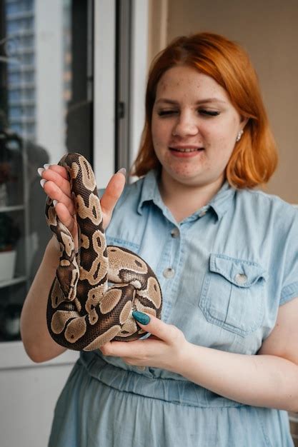 Premium Photo Young Redhead Woman With Acne Holdind Pet Snake In Her