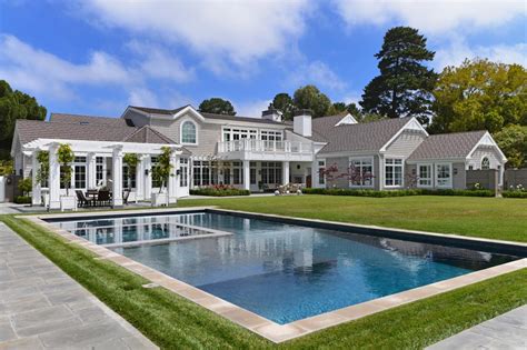The small town is home. Gray Cape Cod With Manicured Backyard and Pool | HGTV
