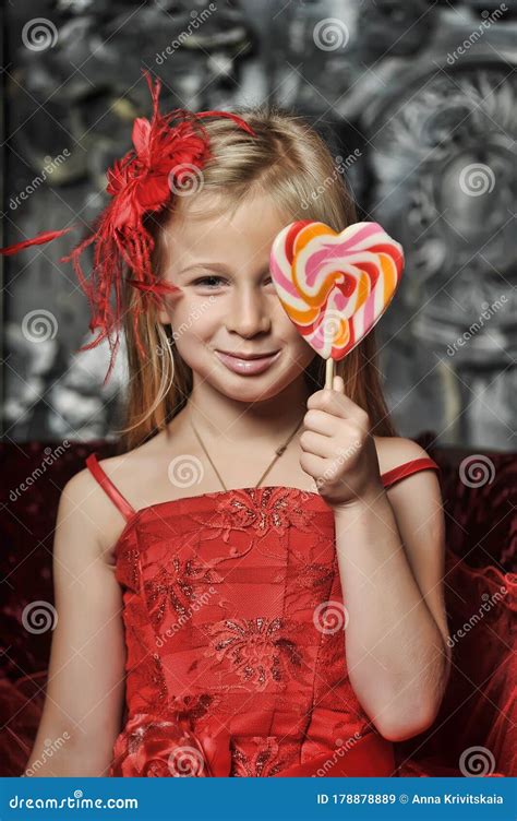 Girl In A Red Dress With Candy In Her Hands Stock Image Image Of Expression Eating 178878889