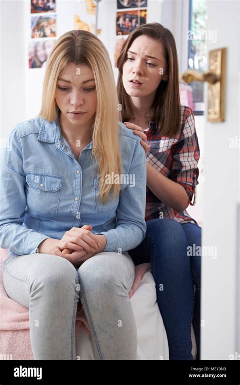 Teenage Girl Comforting Unhappy Friend In Bedroom Stock Photo Alamy