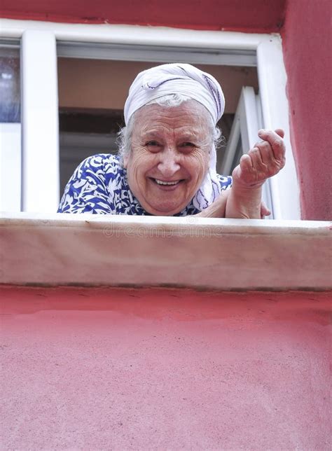 Senior Woman Leaning On Window In Her Apartment Stock Photo Image Of