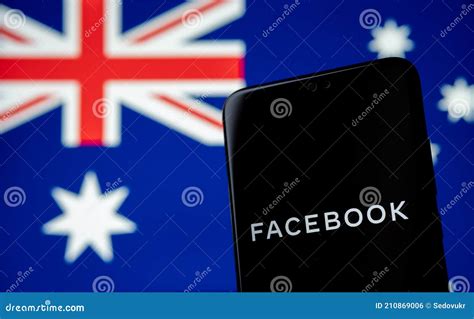 Facebook Logo Seen On The Smartphone And Blurred Australian Flag On The