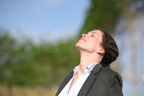 Businesswoman Relaxing Breathing Fresh Air In A Park Stock Photo