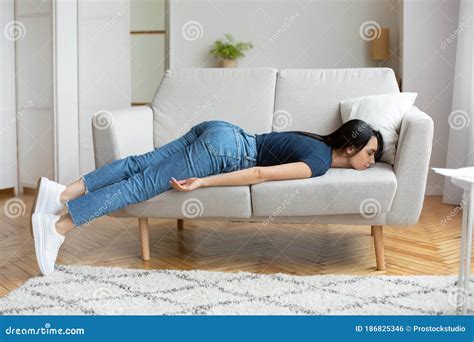 Exhausted Girl Lying On Couch Resting At Home Stock Photo Image Of