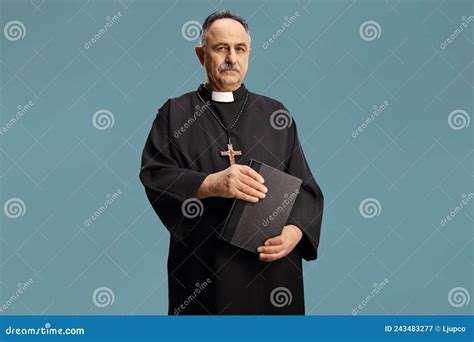 Mature Priest Holding A Bible And Looking At Camera Stock Image Image Of Male Isolated 243483277