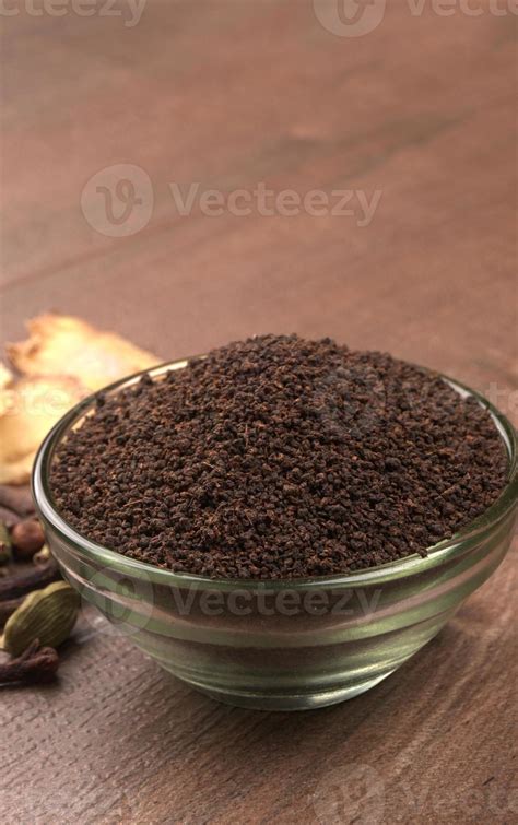 Black Tea Powder Or Dry Dust Tea Powder Chai Patti Isolated In Glass