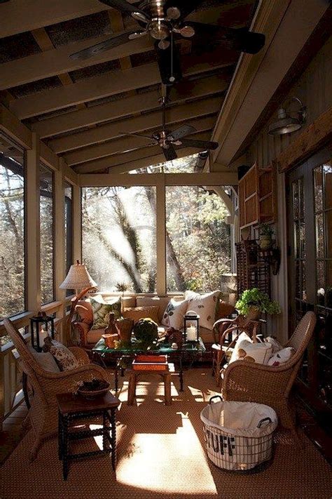 The Sun Shines Through The Windows Into A Screened Porch With Wicker