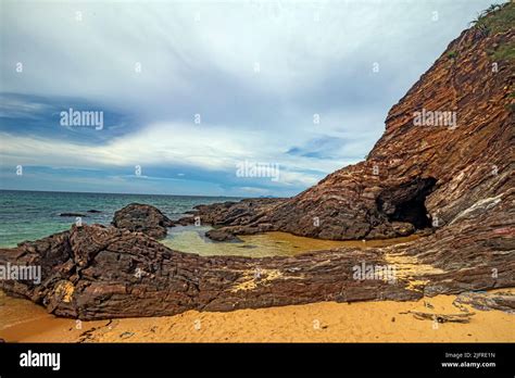 Golden Sand Beach With Rocky Outcrops At Pantai Teluk Bidara Beach In Dungun District Of