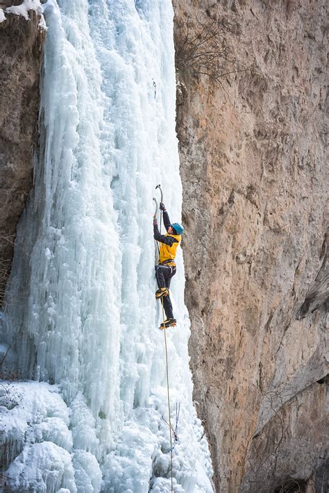 Male Alpinist Ice Climbing On Steep Frozen Waterfall By Stocksy