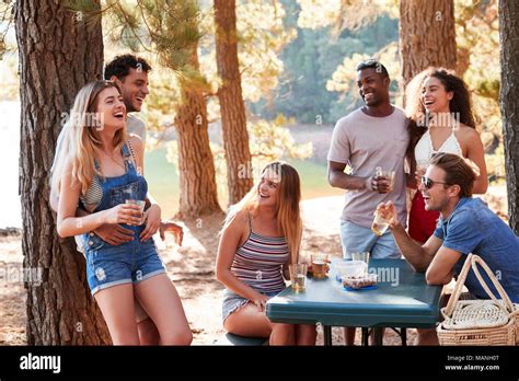 Group Of Adult Friends Hanging Out By A Lake Close Up Stock Photo Alamy