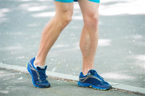 Legs Of Male Athlete Runner Jogging Park Sidewalk Active Lifestyle Training Cardio Sport Shoes