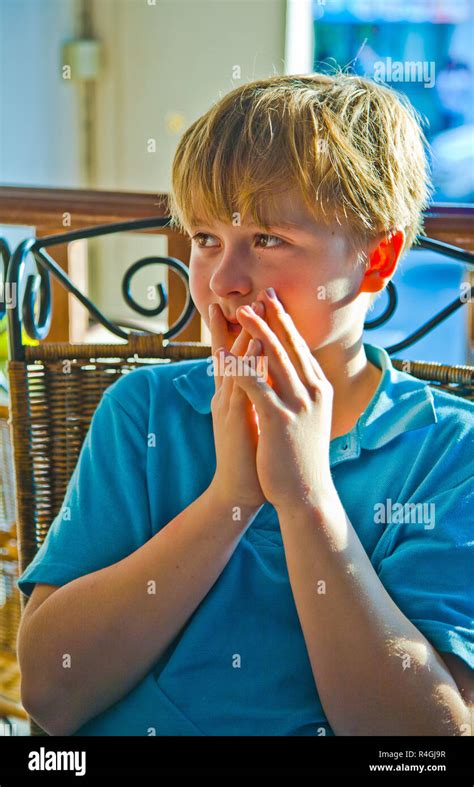 Blond Boy Looks Astonished Stock Photo Alamy