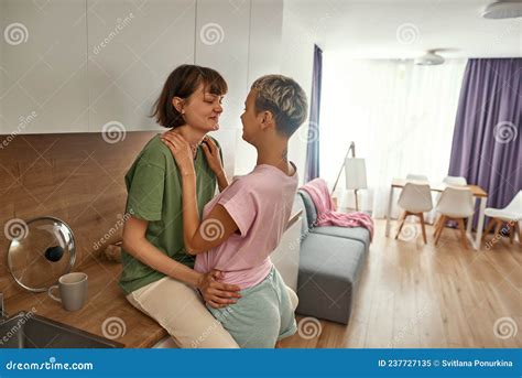 Lesbians Hug And Look At Each Other At Kitchen Stock Image Image Of Kitchen Home 237727135