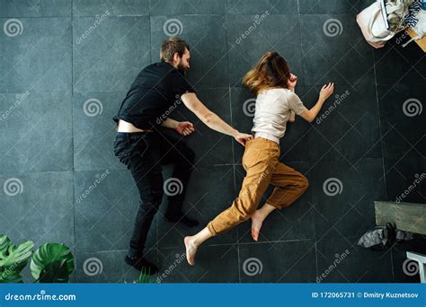 man grabs woman by the waist band as a part of a scene they do on the floor stock image image