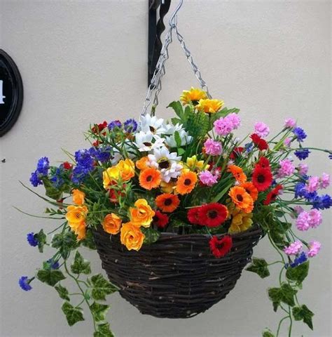 When shopping for your arrangement, look for flowers that have a natural, real appearance and that hang similar to a real flower. Pretty artificial hanging basket of wild flowers - The ...