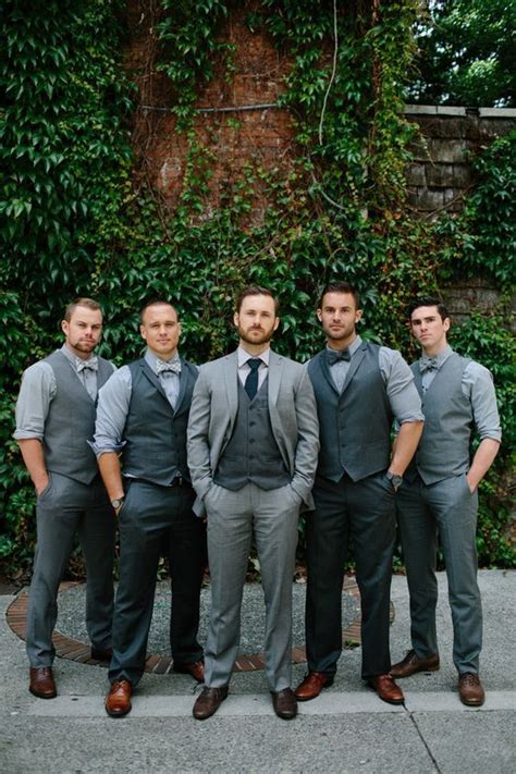 The groomsman in blue suits stand in a row. 9 Popular Grey Suit Wedding Combos - Mens Wedding Style