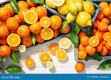 Fresh Citrus Fruits With Leaves On Wooden Background Stock Photo