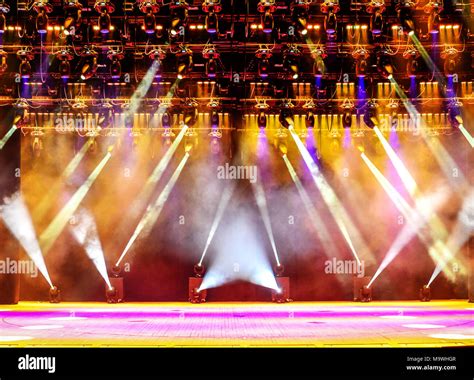 Illuminated Empty Concert Stage With Haze And Rays Of Pink And Yellow