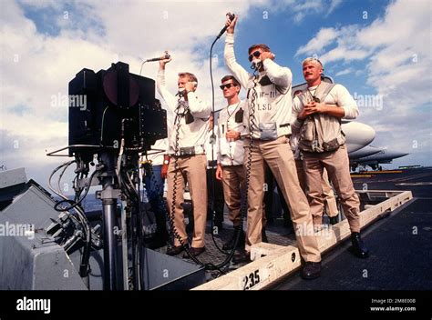 Landing Signal Officers Use Pickle Switches As They Guide Incoming