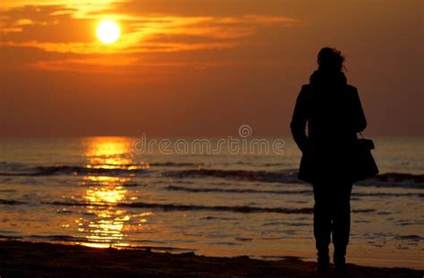 Lonely Woman Watching Sunset Alone In Winter Stock Photo Image Of