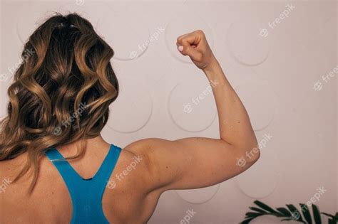 Woman Flexing Back Muscles Woman Flexing At The Gym Stock Photo