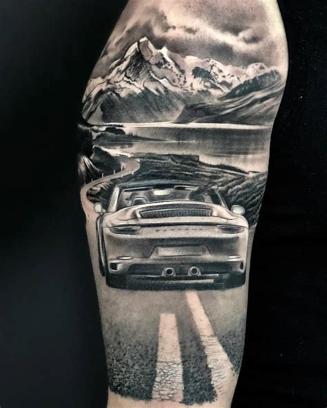 Black And Grey Porsche 911 Tattoo On The Upper Arm