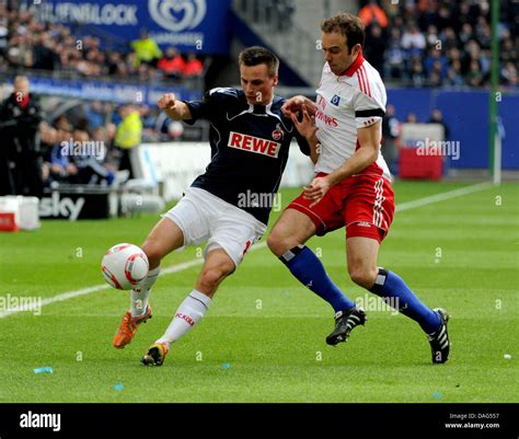 Hamburgs Joris Mathijsen R Tackles Colognes Slawomir Psezko During