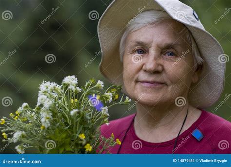 Mature Woman With Flowers Stock Photo Image Of Green