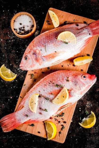 Premium Photo Fresh Raw Fish Pink Tilapia With Spices For Cooking