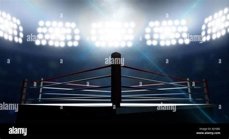 An Boxing Ring Surrounded By Ropes Spotlit By Floodlights In An Arena