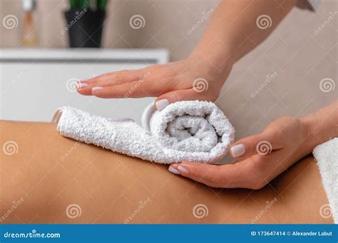 masseur hands doing back massage to client in spa center in dark room stock image