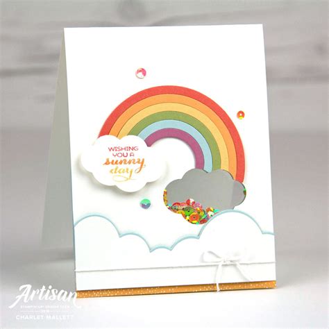 A Card With A Rainbow And Clouds On It