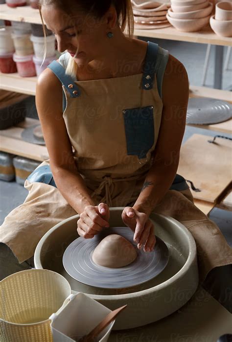 Female Ceramist Preparing To Work On Throwing Wheel At Workshop By Stocksy Contributor Danil