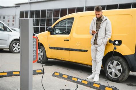 Man Charging His Electric Car Stock Image Image Of Technology Green