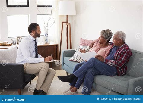senior couple meeting with male financial advisor at home stock image image of people