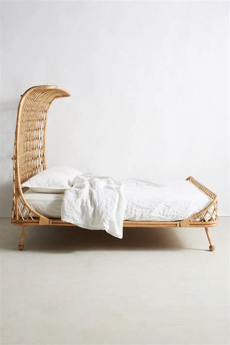 This geometric styled bed has a rattan headboard and a maple bed frame. Curved Rattan Bed | Anthropologie